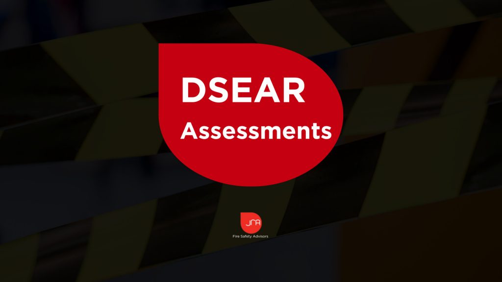 Fire safety assessment report with JRA Fire Safety Advisors logo and safety tape background.