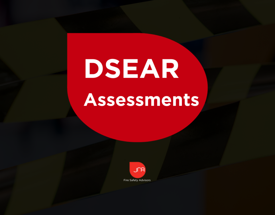 Fire safety assessment report with JRA Fire Safety Advisors logo and safety tape background.