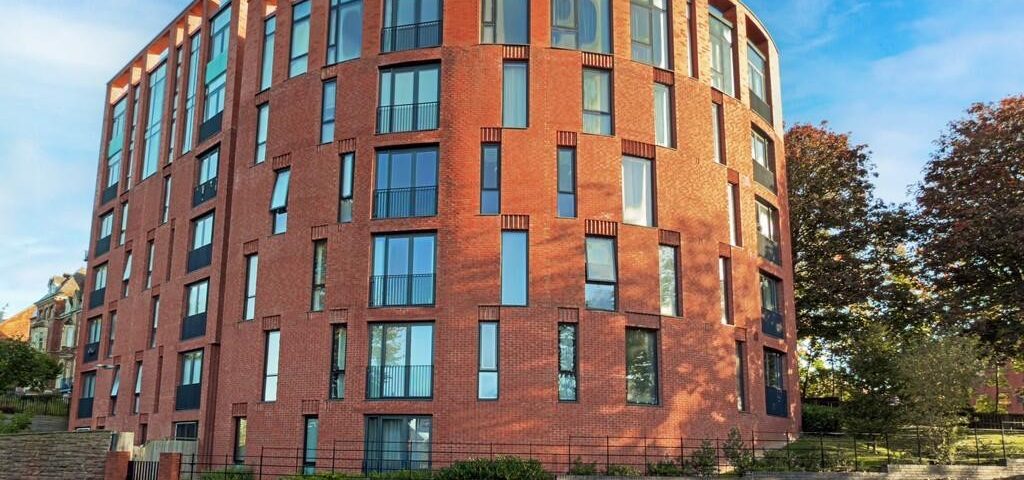 Fire safety advisors consulting modern brick building with large windows for fire risk assessment.