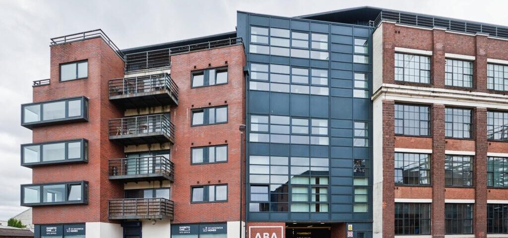 Modern commercial building with fire safety signage and accessible entrances.